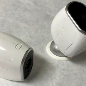 Two Arlo Cameras With Base